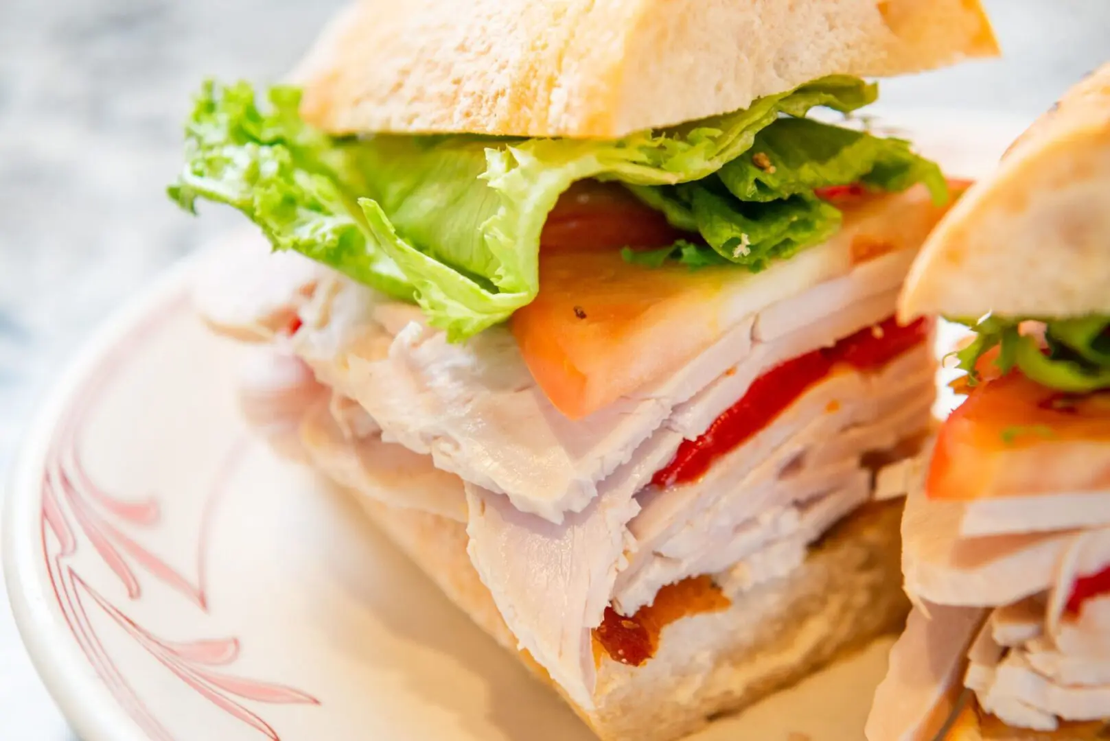 A sandwich cut in half on top of a plate.