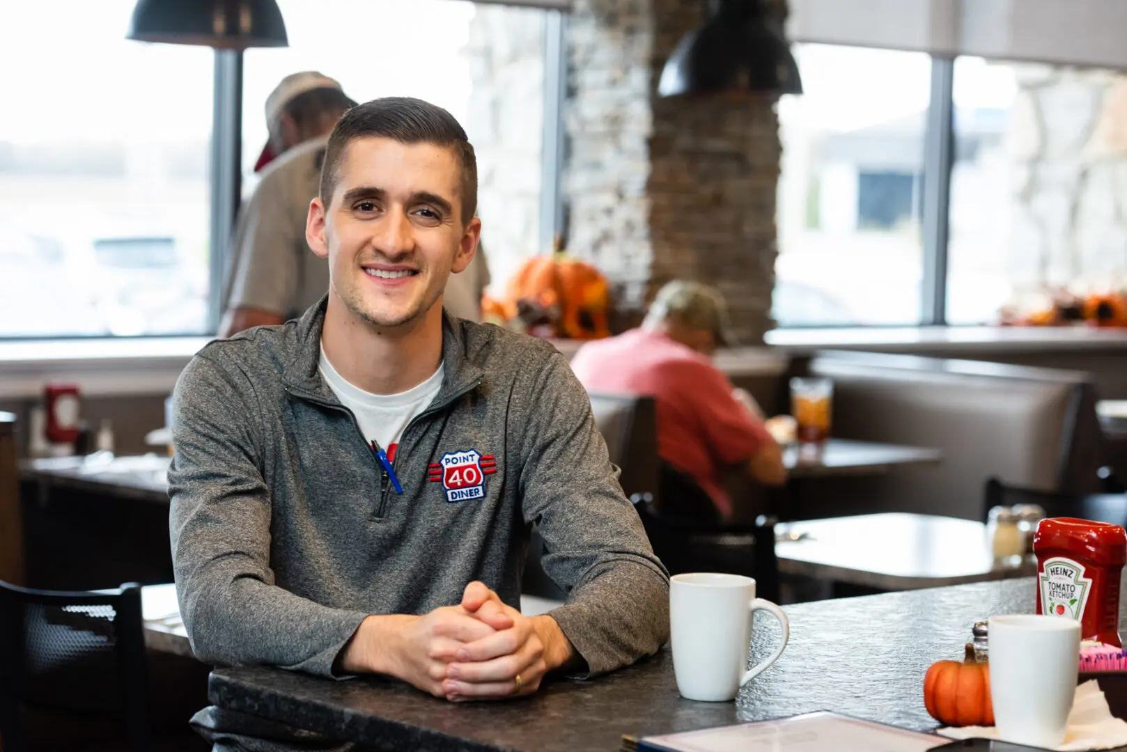 A person sitting on a table in a restraunt.