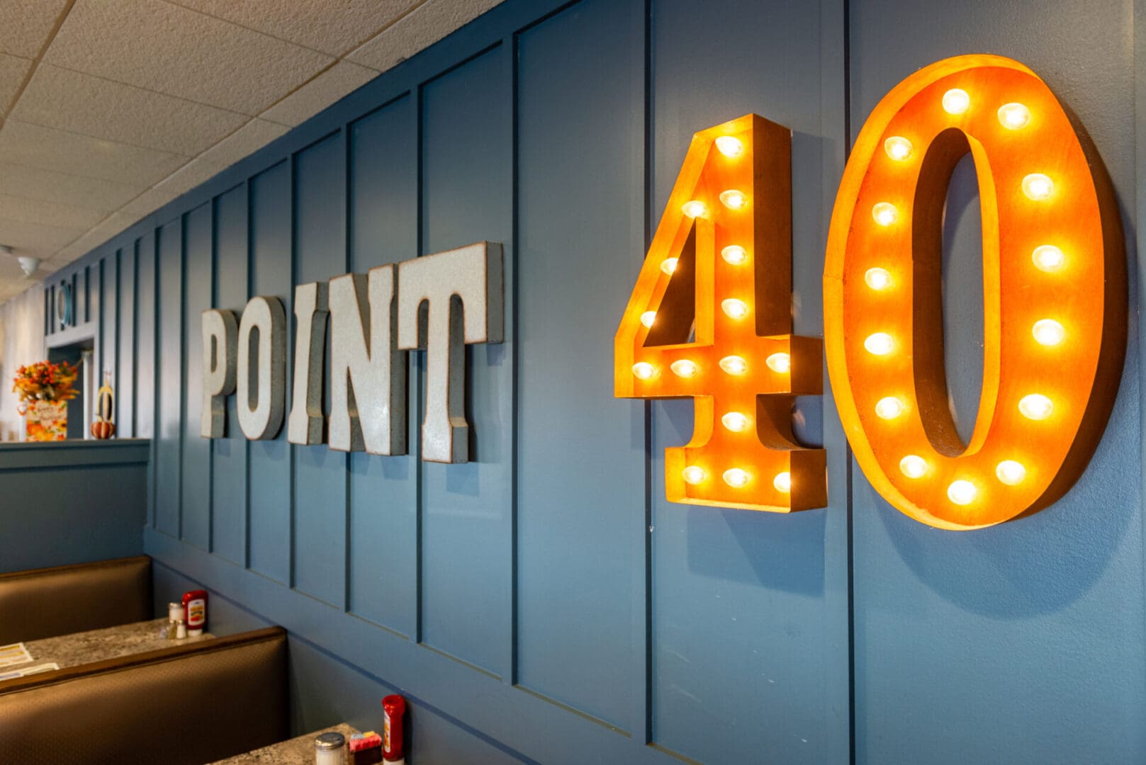 point 40 sign on a gray wall with lights