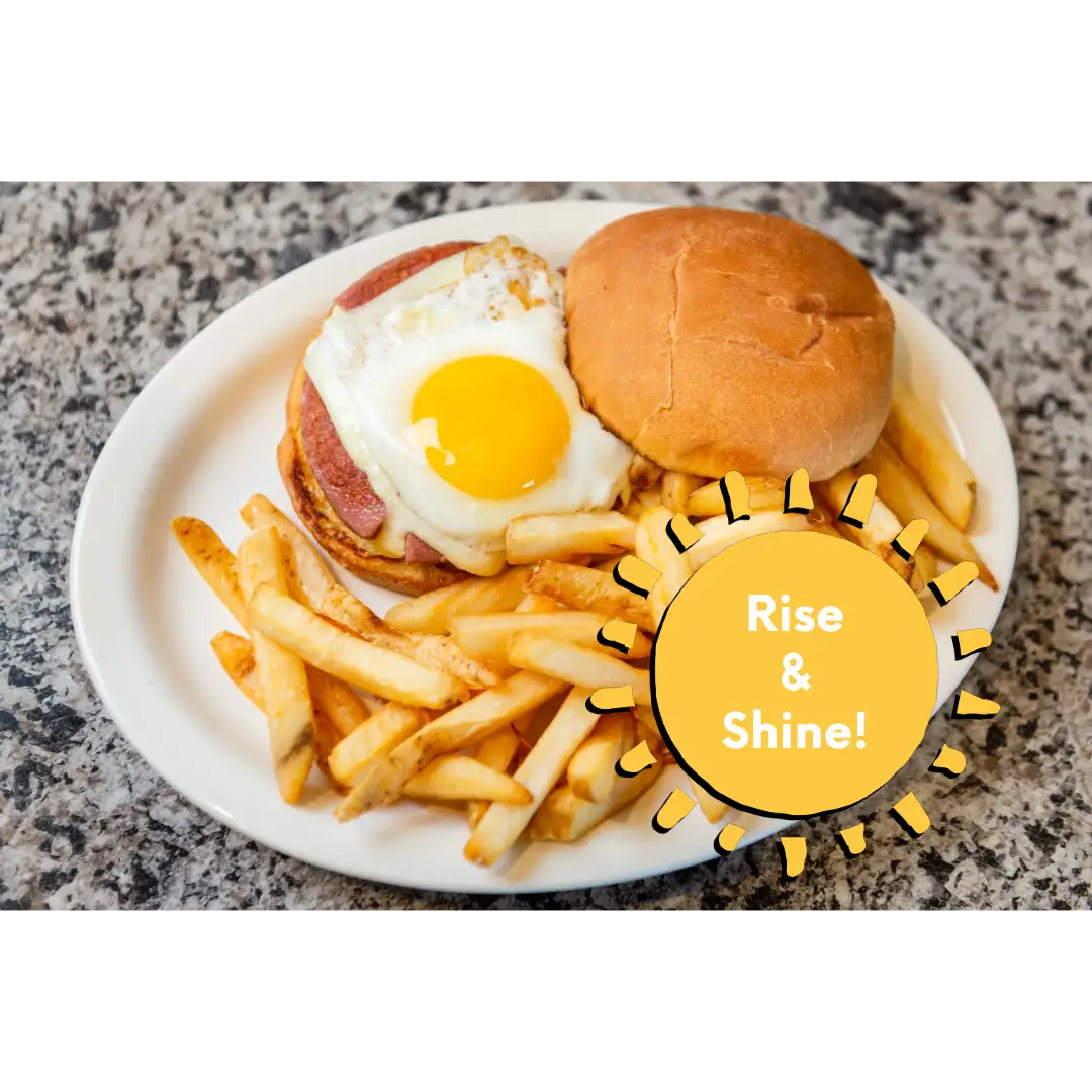 A plate of food with fries and an egg on top.