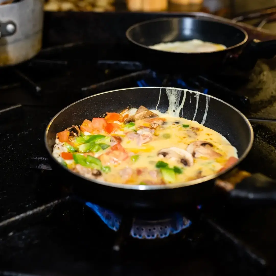 A pan of food on the stove with another pot in it.