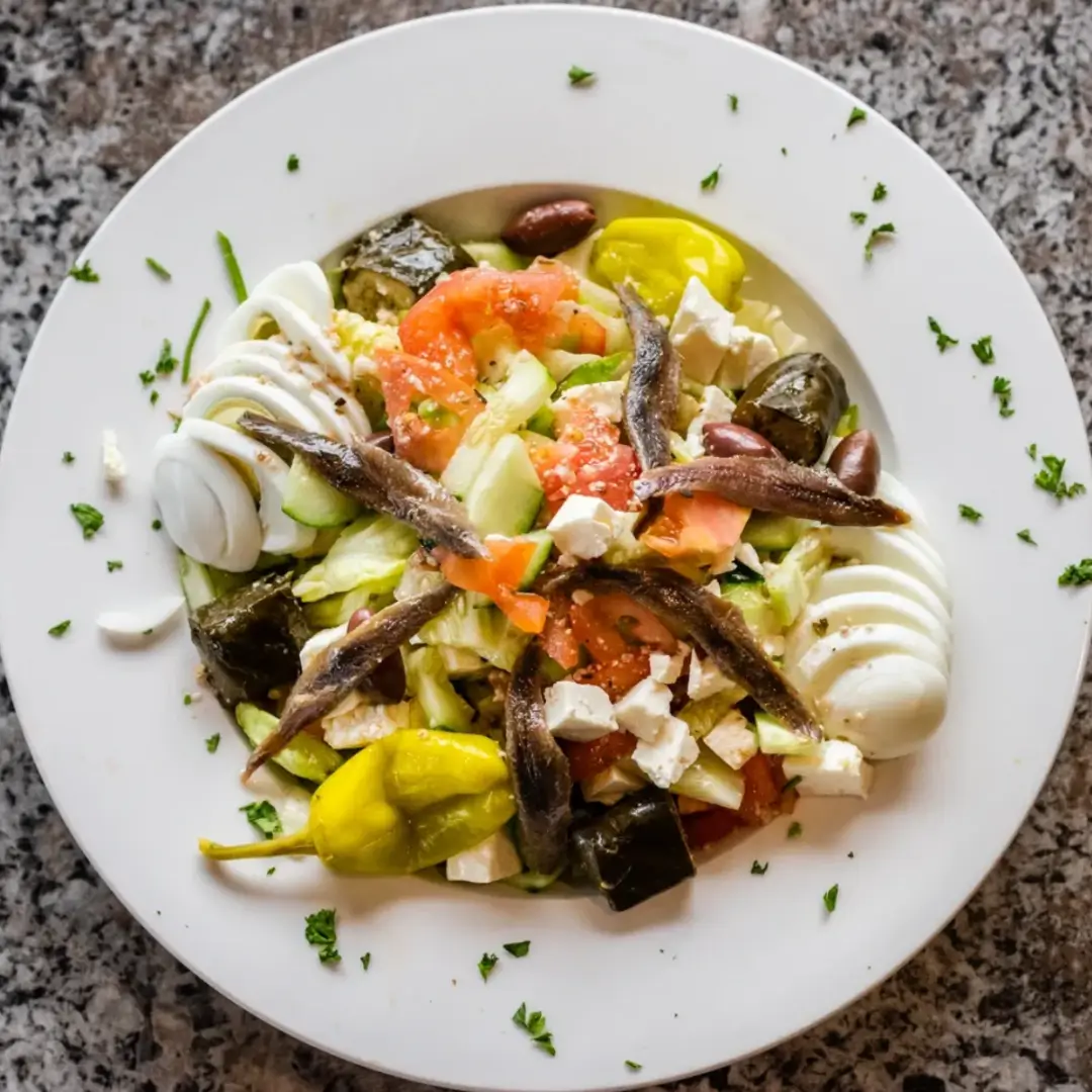 A plate of food with vegetables and sauce on it.